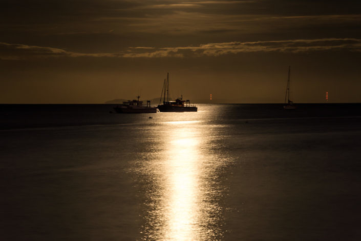 Dive boats in Swanage Bay under a Beaver Moon