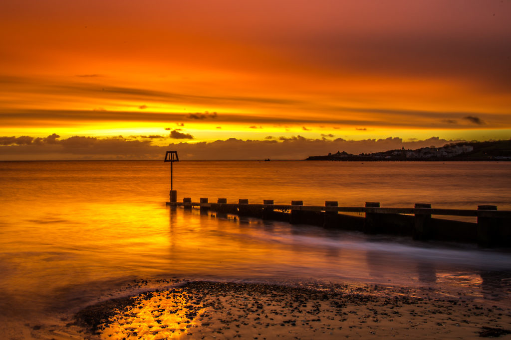 Swanage sunrise picture with fiery sun rise in Swanage Bay